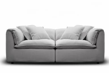A contemporary deep-seated sofa, upholstered in a light gray textured fabric, featuring plush, loose seat and back cushions for maximum comfort. The design includes additional throw pillows and boasts a clean, monolithic silhouette with fully upholstered arms and base. — 3D model