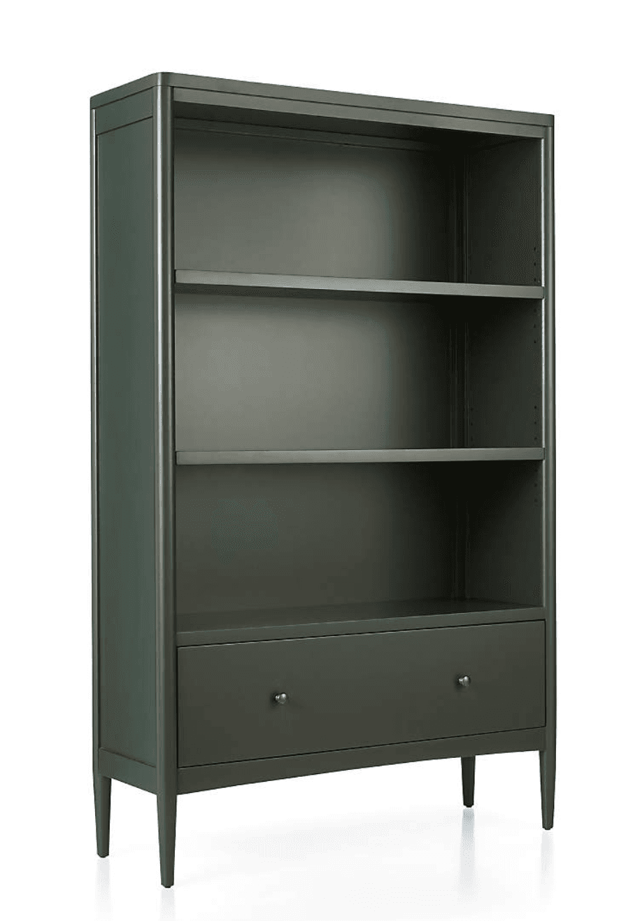A tall, modern bookcase finished in a dark green color, featuring three open adjustable shelves and a single storage drawer at the bottom. It stands on four tapered legs and has two circular gold-tone knob pulls on the drawer. — 3D model