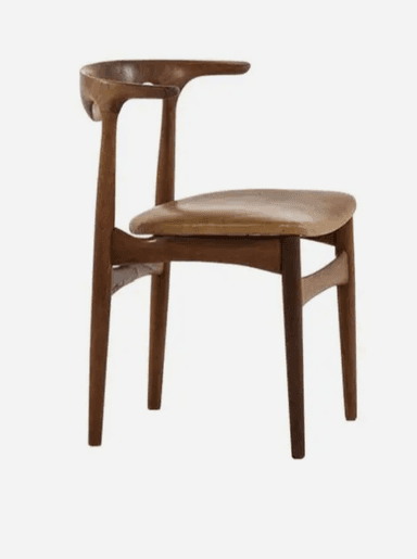 A Mid-Century Modern dining chair crafted from dark wood, featuring a distinctively sculpted backrest that seamlessly transitions into a single, extended armrest. The seat is upholstered in a light tan leather or faux leather, showing some signs of wear. The chair stands on four tapered legs, consistent with Scandinavian design principles. — 3D model