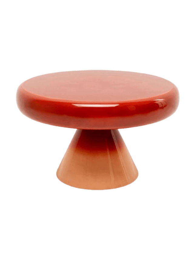 A small, round pedestal table with a glossy finish. The table features a flat, circular top and a conical base. It exhibits an ombre color transition, starting with a deep reddish-orange at the top and gradually fading to a lighter, peach-like orange towards the base. The surface appears smooth and highly reflective, suggesting a ceramic or lacquered material. — 3D model