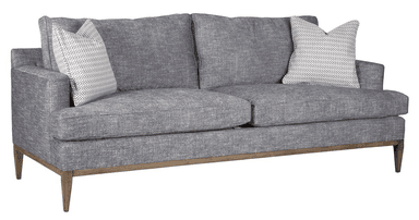 A sofa upholstered in a textured gray fabric. It features a wooden base frame and legs with a natural wood finish. The backrest is composed of two distinct cushions, and an accent pillow with a geometric pattern in white and gray is visible on the left side. — 3D model