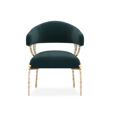 A luxurious barrel-style armchair upholstered in dark teal velvet, featuring an ornate frame with gold-finished metallic sections and sculptural white bone-like embellishments on the arm supports and slender legs. — 3D model