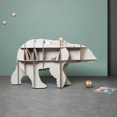 A freestanding shelving unit designed in the shape of a stylized polar bear, featuring multiple open cubby compartments for storage. It is finished in a pale, off-white or light gray color. — 3D model