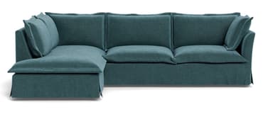 An L-shaped sectional sofa upholstered in a teal fabric, featuring deep seats and a casual, contemporary design. The sofa includes multiple loose back cushions and a wide chaise extension on the left side (when viewed from the front). It has a skirted base, suggesting a relaxed aesthetic. — 3D model