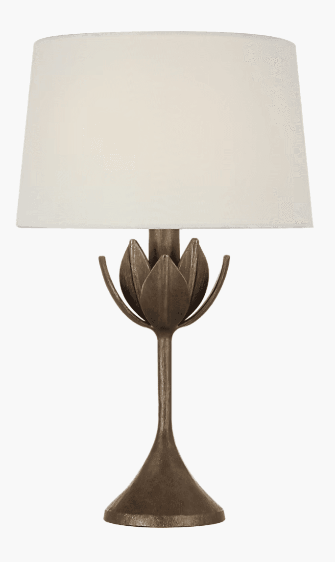 An accent table lamp featuring a bronze-finished metal base with a lotus flower motif and a cylindrical fabric shade. — 3D model
