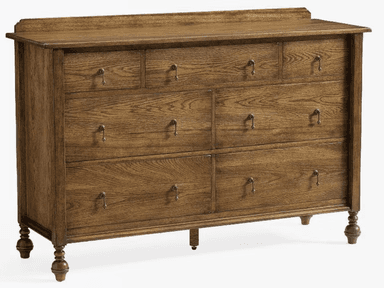 A wooden dresser with multiple drawers. It features a top surface with a raised edge, and a series of drawers of varying sizes arranged in a grid. The drawers are equipped with simple, metallic pull handles. The dresser stands on four turned legs, with the front legs having a more decorative, bulbous shape. — 3D model