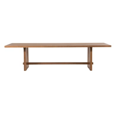 A rectangular dining table constructed from solid wood, featuring a prominent trestle base design. The tabletop is composed of multiple wood planks, exhibiting a natural grain pattern. The base consists of two substantial block-like supports, each with a wide, flat profile, connected by a horizontal stretcher bar. The overall finish is a medium brown, showcasing the wood's inherent texture and color. The design conveys a blend of contemporary and rustic aesthetics. — 3D model