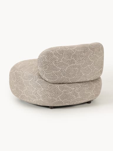 A modern, rounded armchair with a distinctive swirling pattern upholstery. It features a low profile and appears to be upholstered in a textured fabric. The base has short, dark-colored legs. — 3D model