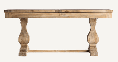 A rustic style dining table crafted from light-toned wood, featuring a rectangular top that appears to be extendable, supported by two heavily turned pedestal bases connected by a central stretcher bar. The wood exhibits a natural, somewhat distressed finish with prominent grain. — 3D model