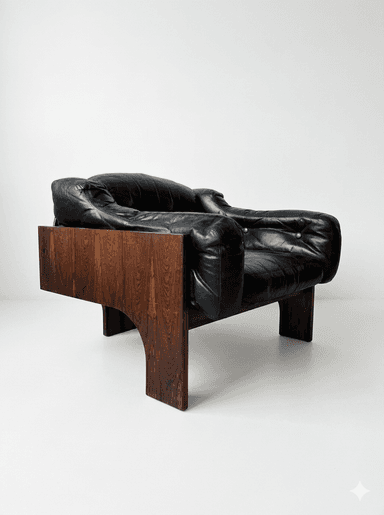 A robust lounge chair featuring a distinctive dark wood veneer frame, likely rosewood, with deep-set black leather cushions. The chair's base forms a solid, geometric structure with cut-out arches, providing a foundational aesthetic. The upholstery consists of plush, padded black leather, including a seat cushion, backrest, and armrests, suggesting a comfortable seating experience. The overall design exhibits characteristics of Mid-Century Modern style with a touch of architectural solidity. — 3D model