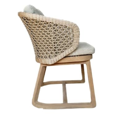 A modern armchair with a woven rattan back and sides, a cushioned seat and backrest, and a light wood frame. The armchair has curved armrests and a contemporary aesthetic, suitable for indoor or outdoor use. — 3D model