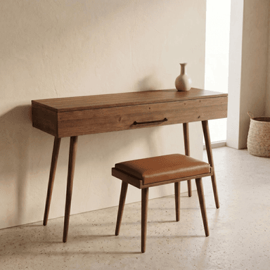 A slender, rectangular console table in a mid-century modern style, featuring a warm, medium-brown wood finish, four tapered splayed legs, and a single drawer with a minimalist black metal bar pull. — 3D model