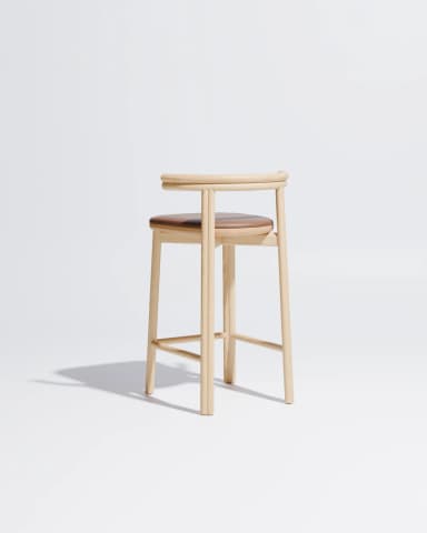 A minimalist bar stool constructed from light-toned oak wood featuring a subtly curved backrest that seamlessly transitions into the side supports. The frame consists of four slender, gently splayed legs connected by horizontal stretchers serving as footrests. A padded seat upholstered in brown leather provides contrast and comfort. The overall design emphasizes clean lines and natural materials, characteristic of Scandinavian or modern minimalist aesthetics. — 3D model