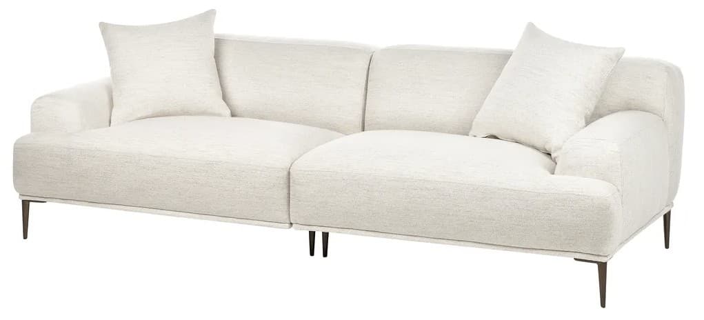 A modern, upholstered sofa with a textured cream-colored fabric. It features a low profile, deep seat cushions, and plush back cushions. Two accent pillows, also upholstered in the same fabric, are placed on the sofa. The sofa is supported by thin, dark-colored legs with a slight outward splay. The design appears modular or sectional, indicated by the visible seam across the seat. — 3D model