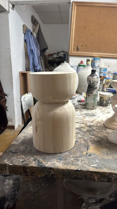 A small, wooden stool with a rounded top section that forms a bowl shape, and a cylindrical base. The design is minimalist and organic. — 3D model