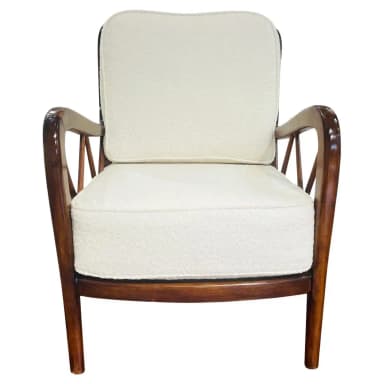 A wooden armchair with a dark stained finish and upholstered seat and back cushions. The armrests have a curved silhouette, and the back features a geometric lattice pattern created by intersecting wooden slats. The legs are slender and tapered. — 3D model
