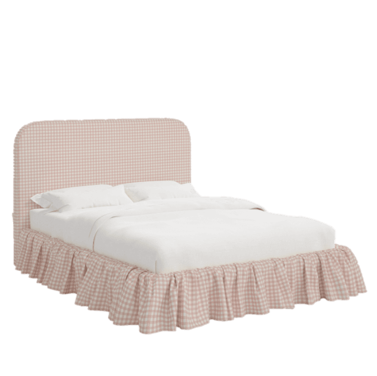 A bed with a upholstered headboard and a ruffled bed skirt. The headboard has a rounded top and is upholstered in a pink and white gingham fabric. The bed skirt is also made of the same fabric and features a ruffled hem. The mattress is covered with white linens. — 3D model