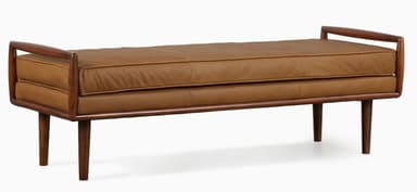 A mid-century modern upholstered bench featuring a solid wood frame with integrated armrests and four tapered legs. The seat is covered in brown leather upholstery. — 3D model