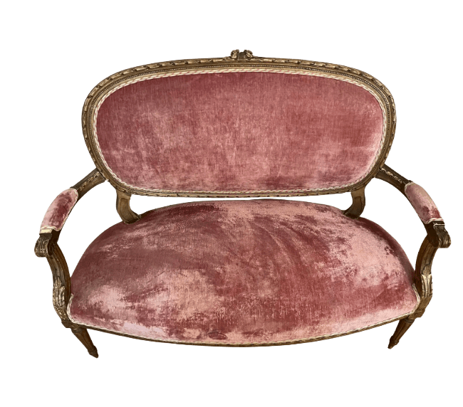 A small, ornate sofa with a curved back and seat upholstered in a dusty rose velvet fabric. The frame appears to be carved wood with a gilded finish. It has open arms with upholstered pads and is supported by four carved legs. — 3D model