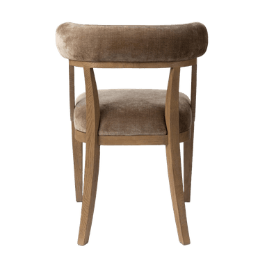 An armless dining chair featuring a light wood frame and velvet upholstery on the seat and a distinctive curved backrest. The chair exhibits a minimalist and contemporary design. — 3D model