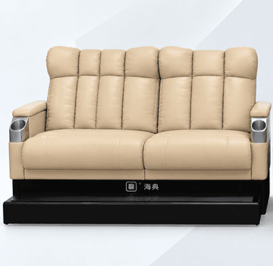 A two-seater home cinema reclining sofa upholstered in light beige (or cream) leather or faux leather, featuring generously padded, segmented backrests and seats. It includes integrated brushed metal cupholders on both armrests and rests on a dark, possibly black, plinth-style base with a glossy dark footrest or platform extending forward. — 3D model