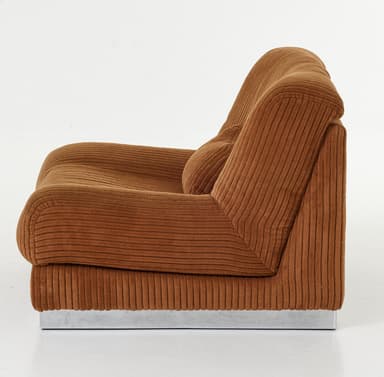 A brown, heavily upholstered lounge chair component with a ribbed corduroy fabric texture, featuring a plush, low-profile design and a slim silver-toned metal plinth base. — 3D model
