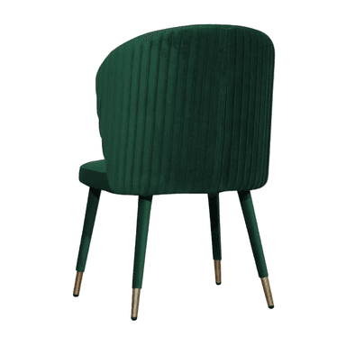 A contemporary accent chair upholstered in emerald green velvet. It features a gently curved, high back and a padded seat. The chair is supported by four slender, tapered legs made of metal with a brass finish at the foot of each leg. — 3D model