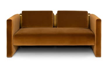 A contemporary two-seater sofa with a minimalist design. The sofa features a plush velvet upholstery in a warm brown hue. Its structure is characterized by clean lines, with substantial armrests and back cushions. Accents of polished brass or gold-toned metal are visible at the top of the armrests and between the back cushions, providing a luxurious contrast to the fabric. — 3D model