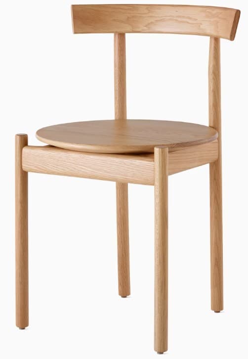 A wooden chair with a circular seat and a gently curved backrest. The chair features four cylindrical legs and a minimalist design, showcasing the natural wood grain. — 3D model