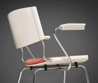 A modern armchair with a tubular metal frame and a molded plastic shell seat and back. The seat and back are upholstered with a textured orange-red fabric. The armchair features slender, chrome-plated legs that splay outwards and integrated armrests. — 3D model