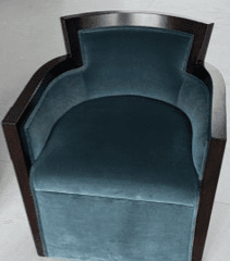 A pair of teal velvet upholstered club chairs with a dark exposed wooden frame, featuring a curved barrel back design and vertical channel tufting on the exterior. — 3D model