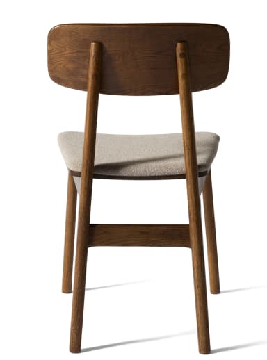 A contemporary dining chair featuring a solid oak wood frame with a clear, light-brown finish and a subtly curved wooden backrest. The seat is upholstered in a light beige, textured fabric. The chair stands on four sturdy, tapered wooden legs, with visible wood grain throughout the frame, suggesting a natural and minimalist design. — 3D model