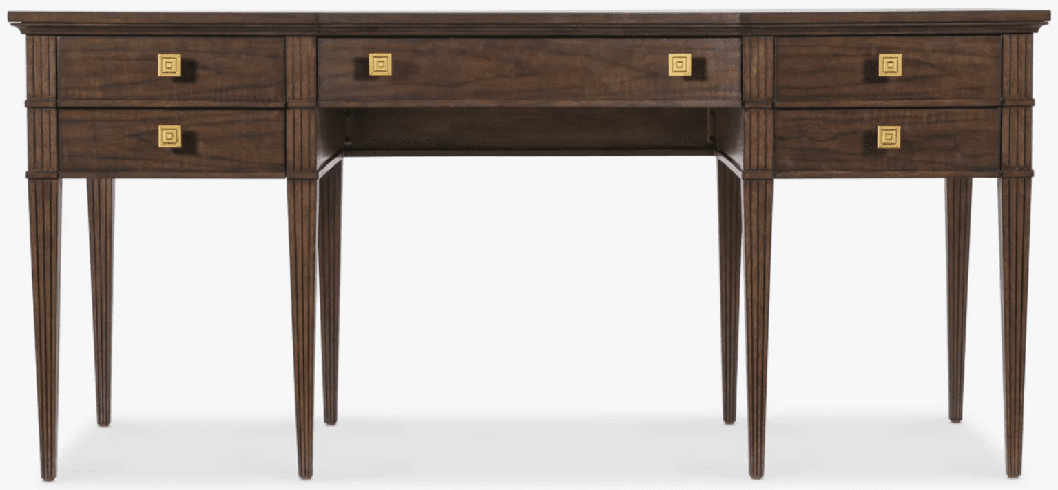 A dark brown wooden desk featuring a rectangular top, multiple drawers, and reeded tapered legs. The desk has a central knee space, flanked by two sections each containing two stacked drawers. Above the knee space, there is a single, shallower drawer. All drawers are fitted with square brass pulls featuring an etched geometric pattern. The reeded texture is present on the vertical elements of the frame and the tapered legs, adding a classical detail to the transitional design. — 3D model