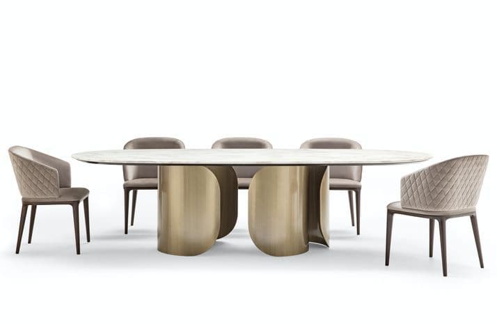 An oval dining table with a marble top and a sculptural metallic base, accompanied by six upholstered dining chairs with wooden legs. The table base features two large, curved, metallic elements that support the tabletop. The chairs have a diamond-stitched upholstery pattern. — 3D model
