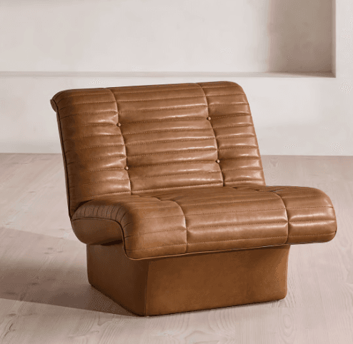 A single-seater armchair upholstered in brown leather with a tufted and channel-stitched design. The chair features a low-profile, boxy base and integrated armrests that flow into the seat and backrest. The upholstery exhibits consistent stitching and button tufting on the backrest and seat cushion. — 3D model