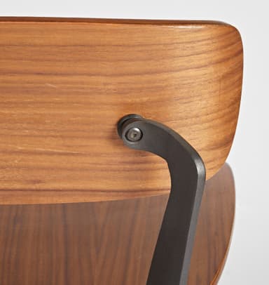 A bar stool with a backrest, featuring a wooden seat and back panel, supported by a dark metal frame. The seat and back panel appear to be made of bent wood or plywood with a wood grain finish. The frame consists of angled legs connected by a footrest at the bottom and supports for the seat and back. The design is modern and minimalist. — 3D model