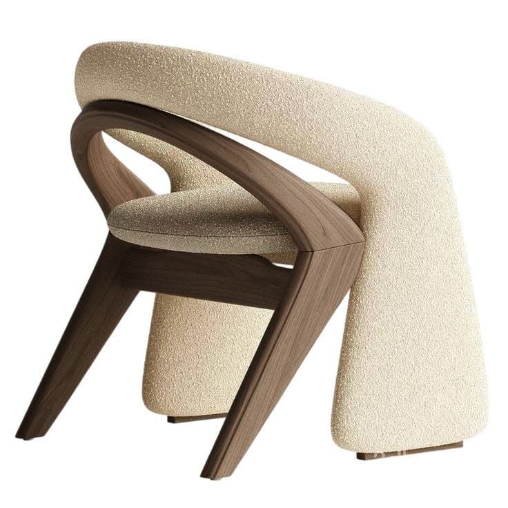 A contemporary armchair featuring a sculptural dark walnut frame and plush, light-colored boucle upholstery. The backrest is a continuous, curved, and fully upholstered element that appears to float above the wooden seat frame, extending to provide integrated arm support. The wooden frame consists of angled, tapered legs and a sinuous structure that cradles the upholstered components. — 3D model