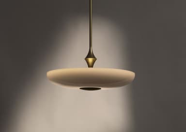 A modern pendant light featuring a wide, shallow, disc-shaped shade suspended by a slender metallic rod, accented by a decorative tapered element. — 3D model