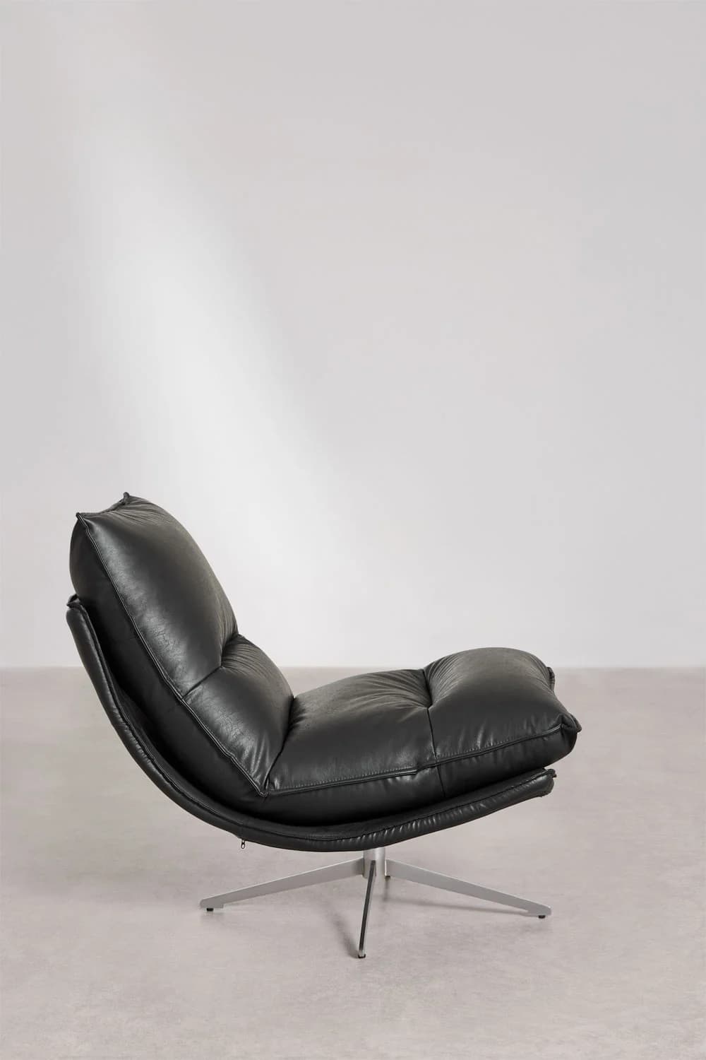 A contemporary black leather lounge chair with a tufted, cushioned seat and back. The chair features a low profile and a curved silhouette that cradles the sitter. It is supported by a sleek, brushed metal four-star base, allowing for swivel functionality. — 3D model