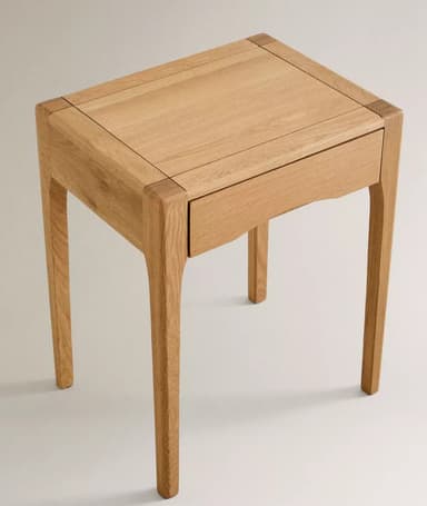 A light-toned wooden nightstand or side table, characterized by its clean, minimalist design and sturdy construction. It features a single, recessed drawer with a subtle, integrated curved handle and four slender, straight legs. The wood exhibits a fine grain, indicative of oak or a similar hardwood. — 3D model