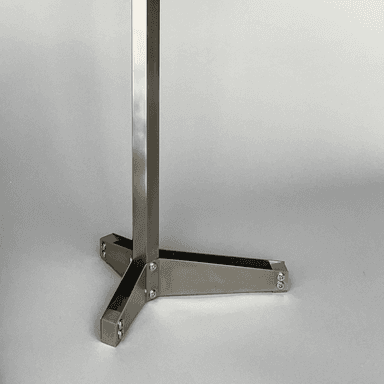 A hexagonal side table with a copper-colored top and a brushed metal pedestal base. The top is secured to the base with three visible screws. The base has a modern, geometric design with three legs splayed outwards from a central column. — 3D model