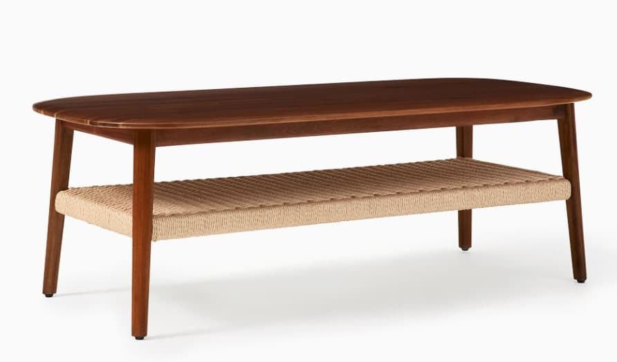 A mid-century modern coffee table featuring a rectangular, dark wood top with rounded corners. It is supported by four tapered wooden legs. A lower shelf, constructed from woven natural fiber or cordage, spans the width between the legs, providing additional storage or display space. The design emphasizes natural materials and clean lines. — 3D model