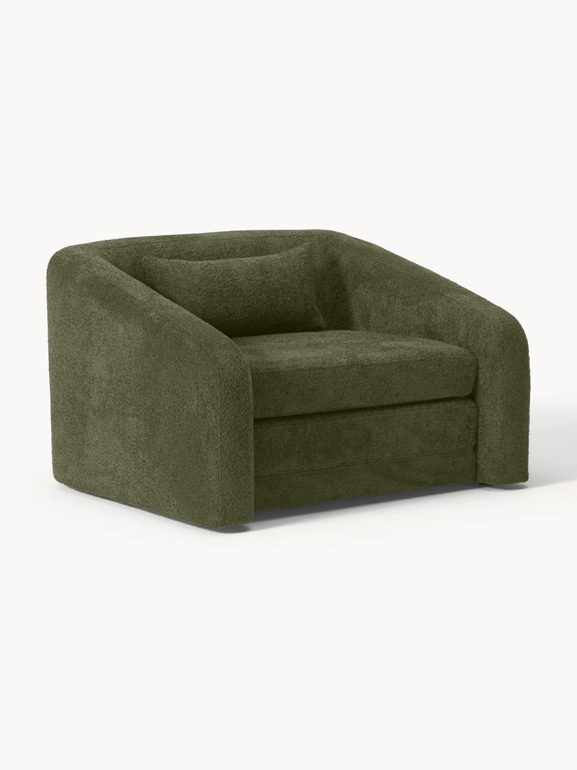 A modern, rounded armchair with a plush, textured upholstery and a single matching throw pillow. The armchair has a low profile and appears to be designed for comfort. — 3D model