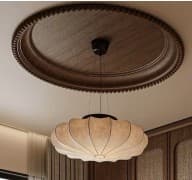 A pendant light featuring a pleated fabric shade, suspended by a black cord and canopy, and adorned with a circular carved wooden ceiling medallion. — 3D model