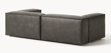 A dark grey modular sectional sofa, upholstered in distressed faux leather, featuring a low profile and rounded, plush cushions, seen from the rear and side. — 3D model