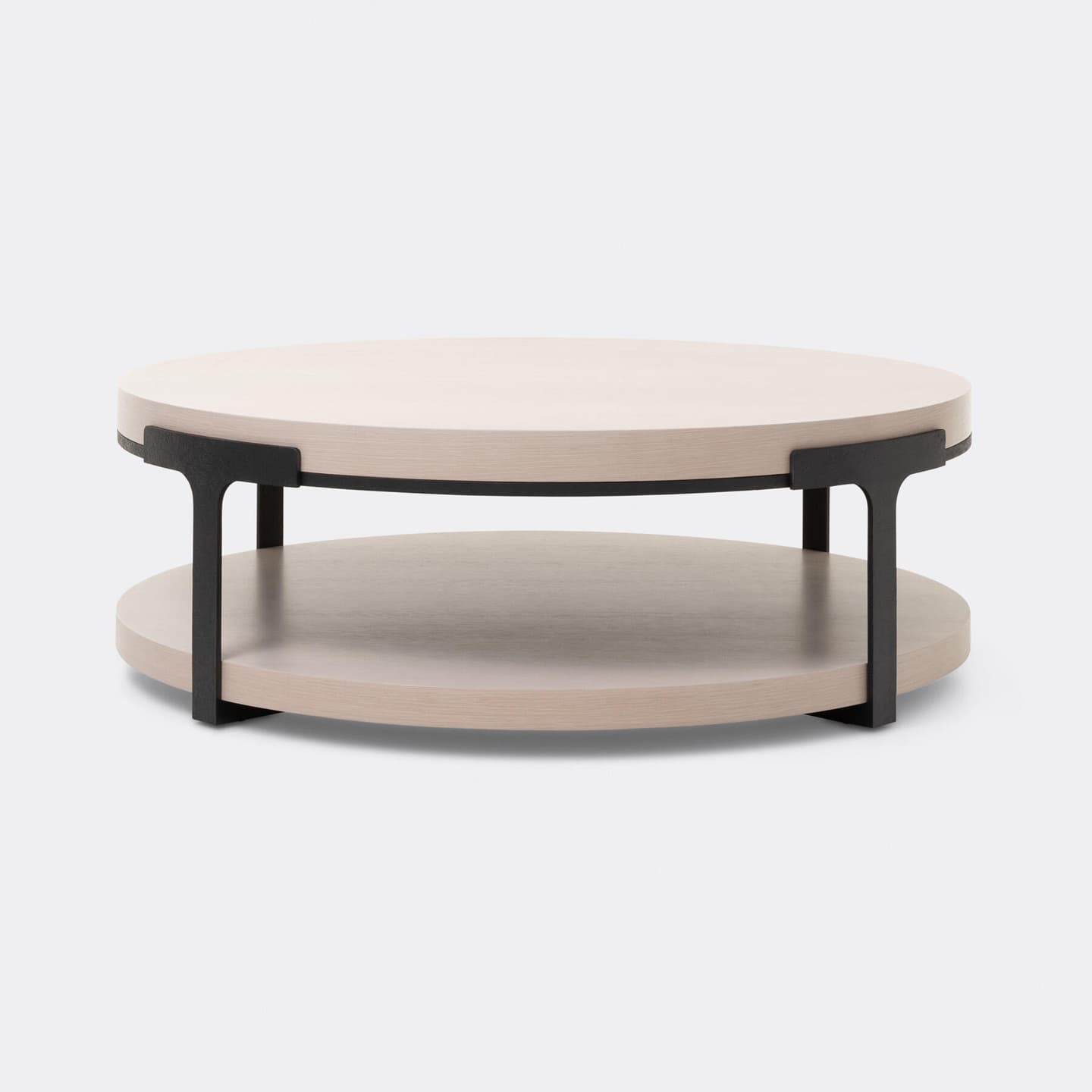 A contemporary round coffee table with a two-tiered design. The table features two circular surfaces, likely made of wood or a wood composite, with a light, natural wood grain finish. These surfaces are supported by a dark, possibly black metal frame consisting of vertical supports and horizontal bracing between the tiers. The overall aesthetic is minimalist and modern. — 3D model
