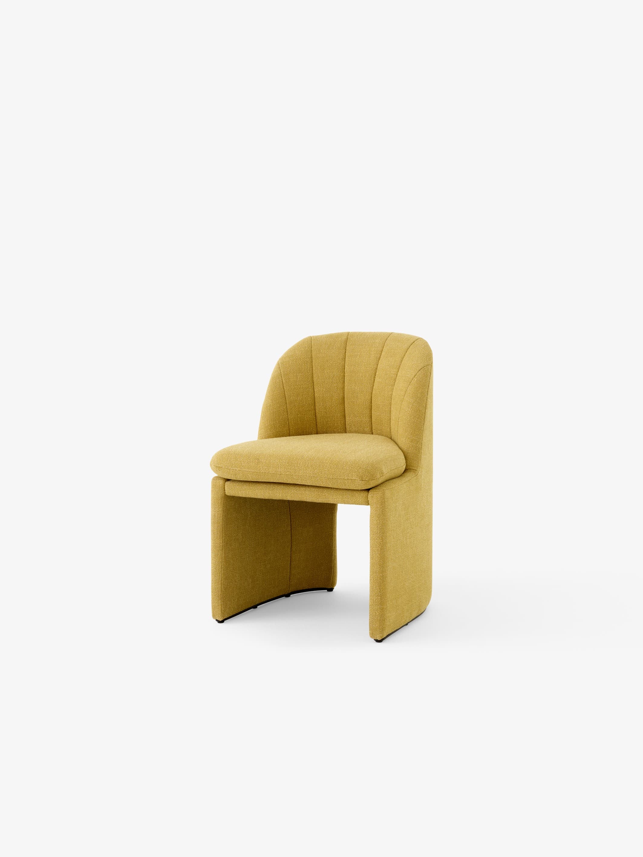 A modern armchair with a curved backrest and seat upholstered in textured mustard-yellow fabric. The backrest features vertical channel tufting. The base is formed by two curved, solid panels that create a sled-like effect, with a thin black element visible at the bottom of each panel. — 3D model