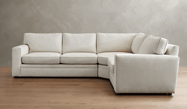 A sectional sofa with a textured, light-colored upholstery. It features a modular design with multiple seating sections, including an armrest on the left side and a corner section. The sofa has plush seat cushions and back cushions, with piping detail along the edges. The style is contemporary and minimalist. — 3D model