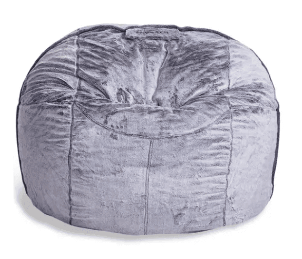 A round, amorphous bean bag chair upholstered in a grey, mottled faux fur fabric, featuring visible stitching that creates a segmented appearance. A small fabric handle is present at the top. — 3D model