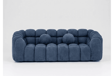 A modern three-seater sofa characterized by its sculptural, rounded, segmented design, upholstered in a deep blue velvet-like fabric and accompanied by two matching spherical toss pillows. — 3D model